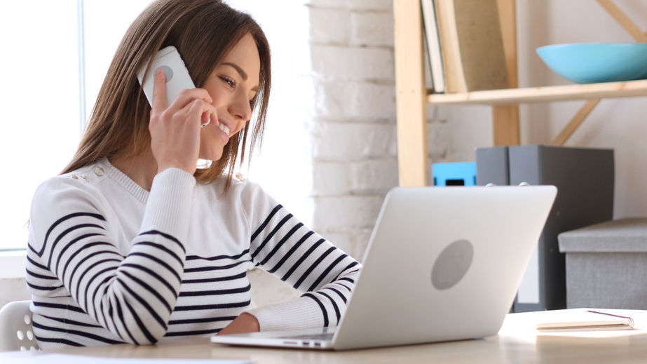 Woman on phone in teletherapy session.